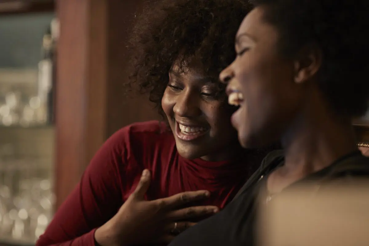 emotional-health-1200×800 Two African American women laugh playfully together